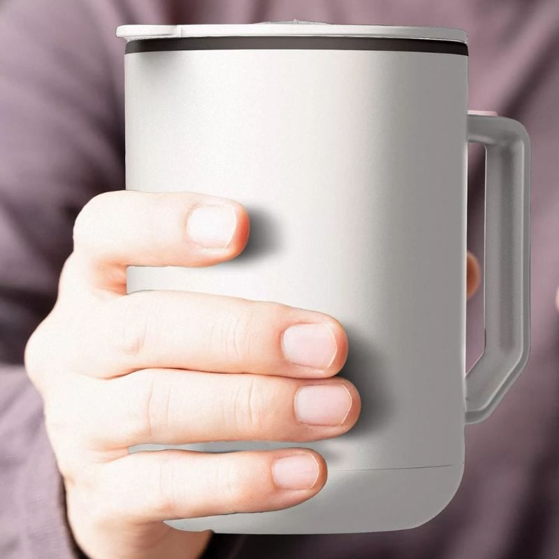 hand holding warming coffee mug