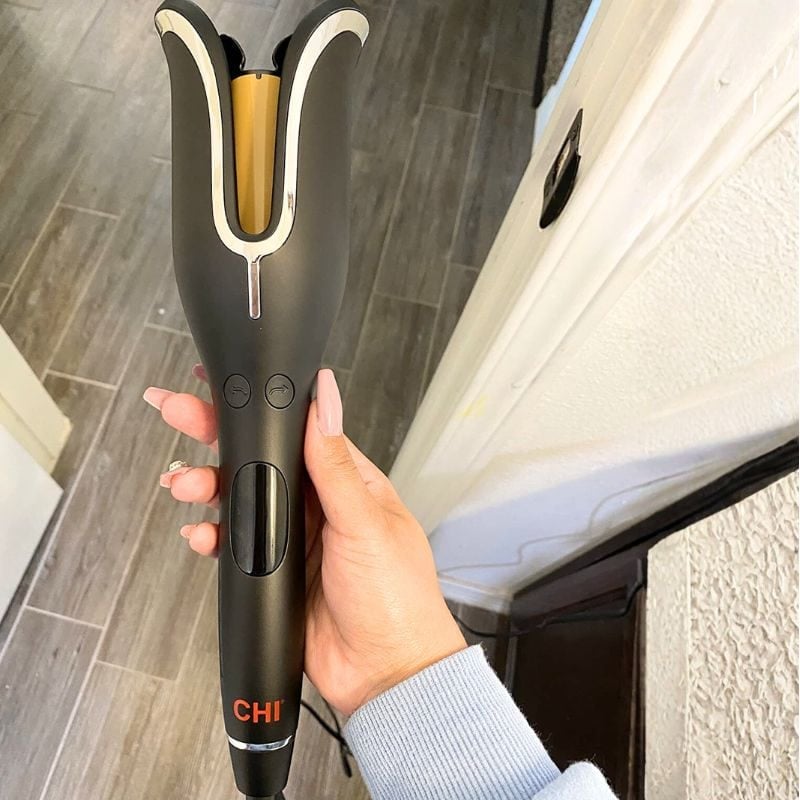 person holding up black chi spin