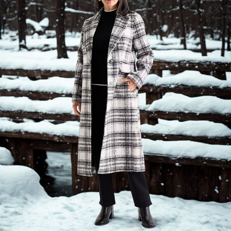 woman wearing long plaid coat in snow