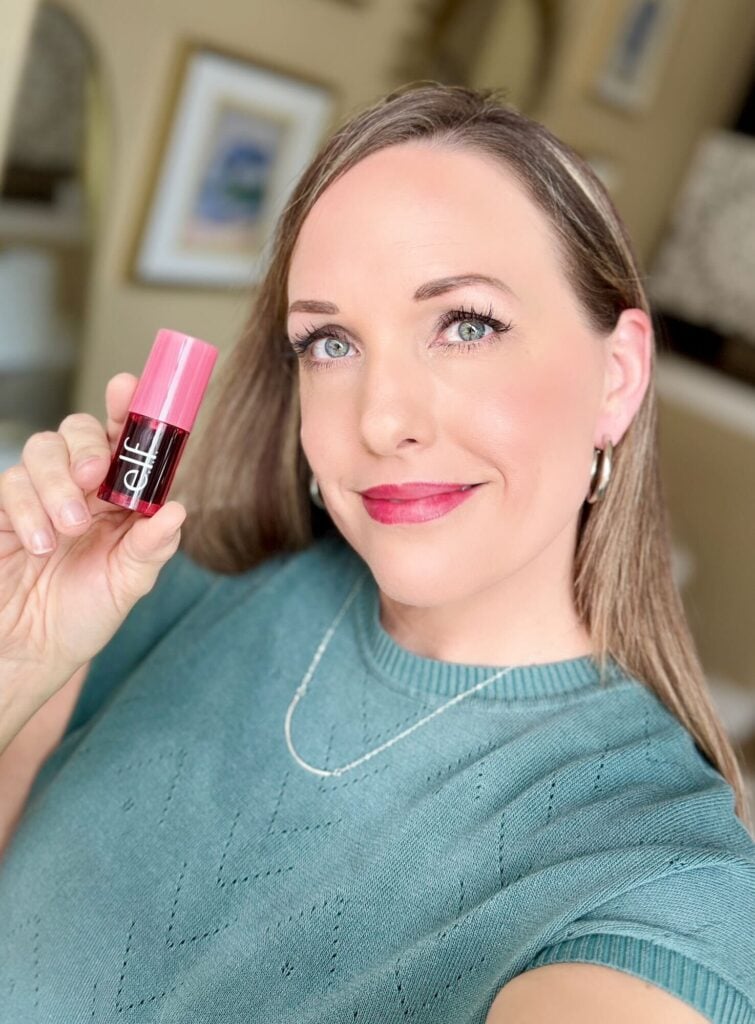woman holding up elf lip and blush tint