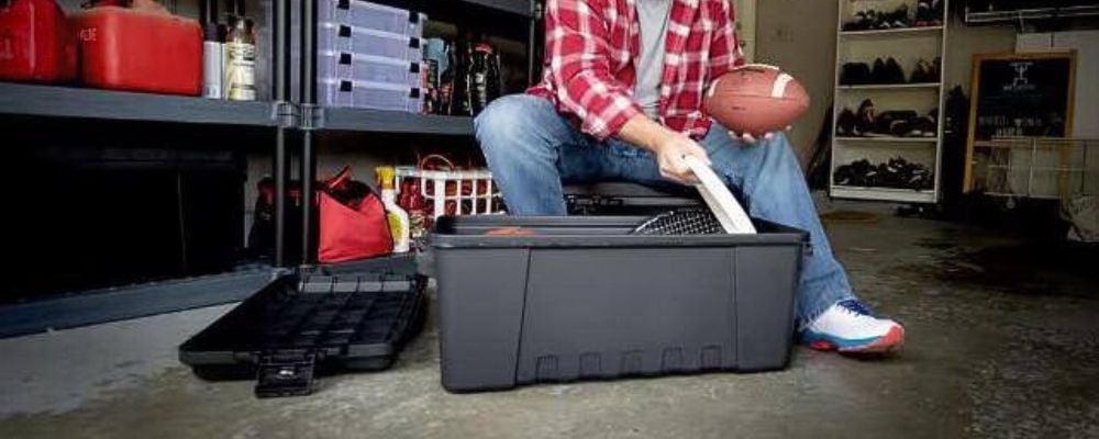 man taking stuff out of black storage tote