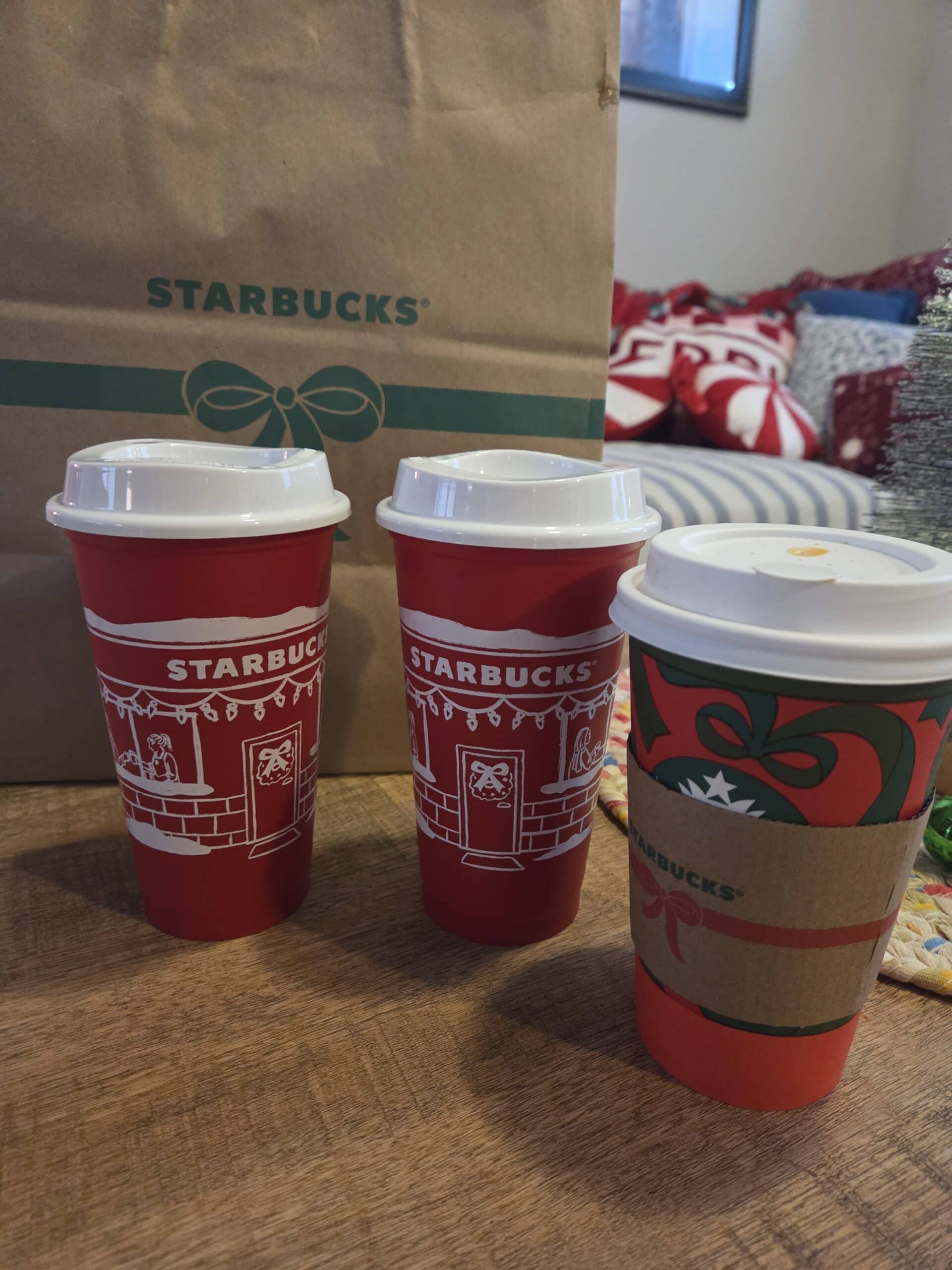starbucks red cup with holiday drink in front 