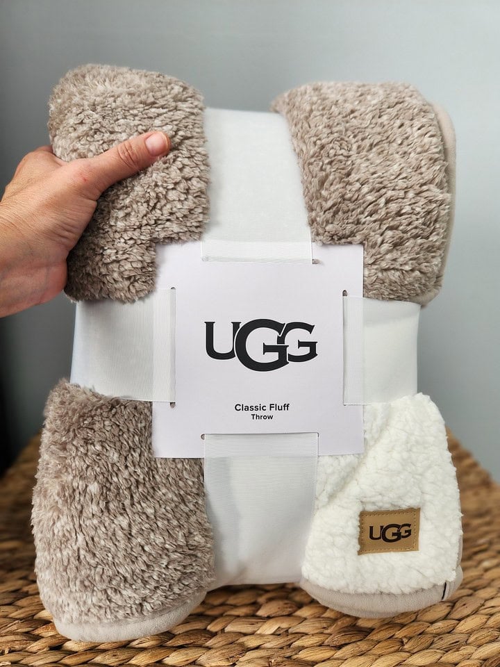 person holding UGG throw