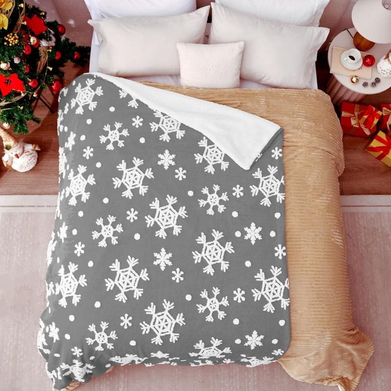 gray snowflake throw blanket on bed