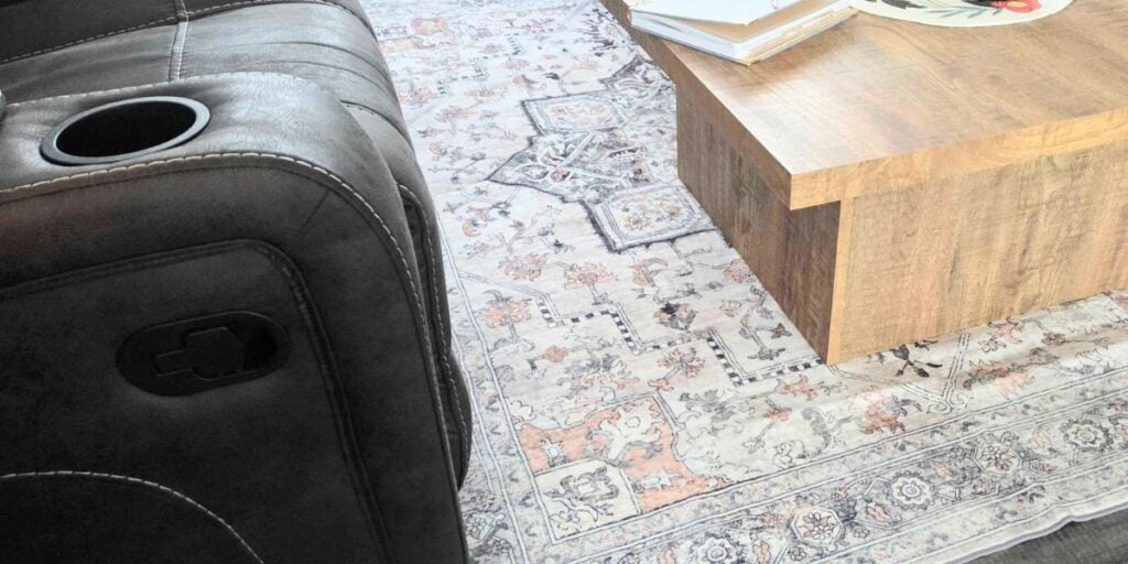 light patterned area rug with coffee table on it