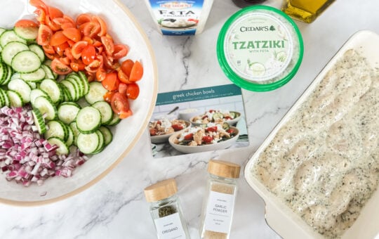 greek chicken bowls ingredients on counter with recipe card