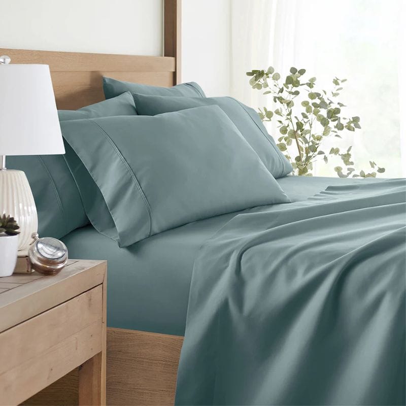 teal sheet set on bed in bedroom