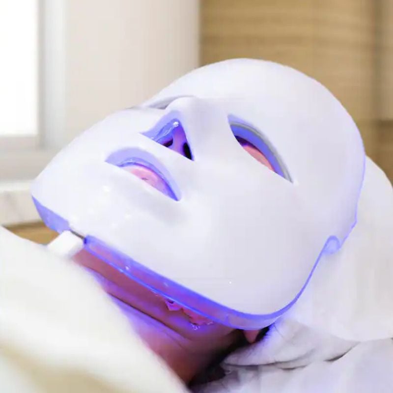 person wearing red light therapy mask