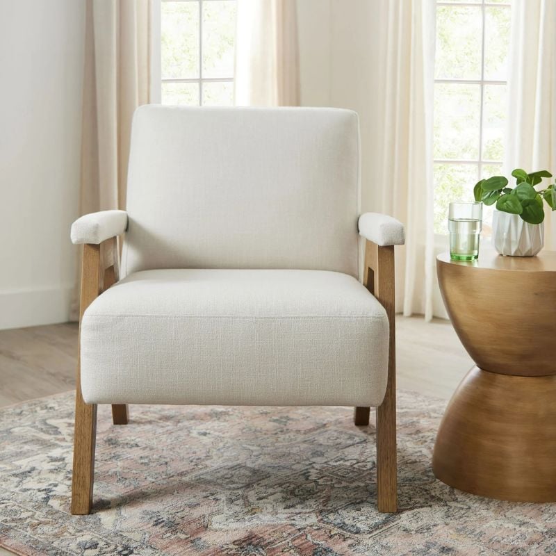 cream colored accent chair with wooden legs