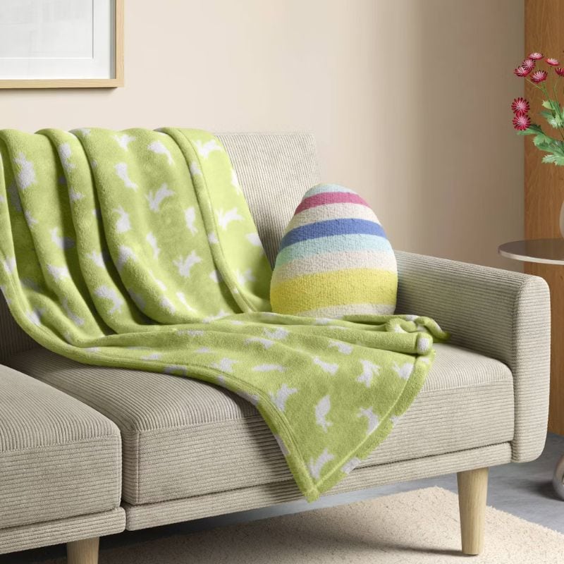 Easter throw blanket on couch with egg shaped throw pillow