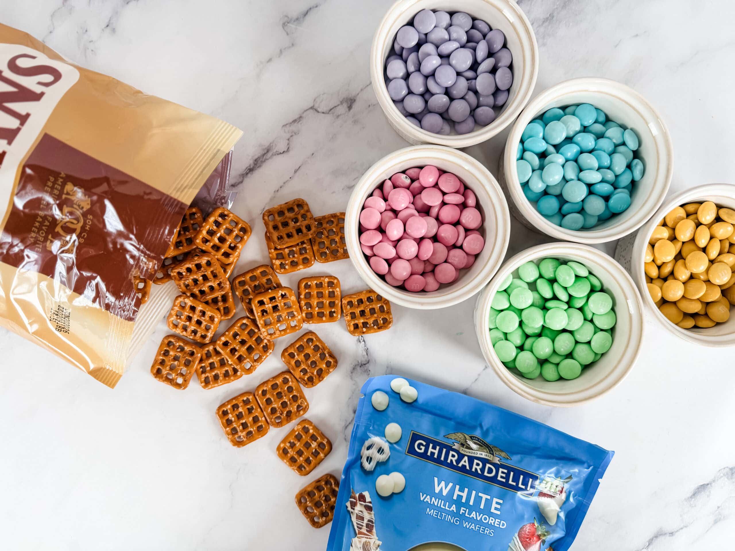 colorful m&ms for pretzel flower bites on countertop