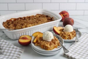 Cake Mix Peach Cobbler Baked and plated with vanilla ice cream