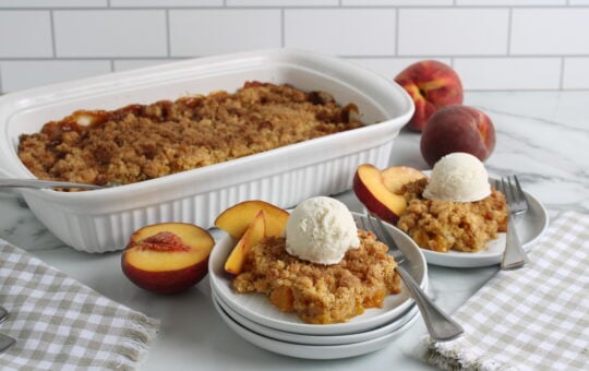 Cake Mix Peach Cobbler Baked and plated with vanilla ice cream