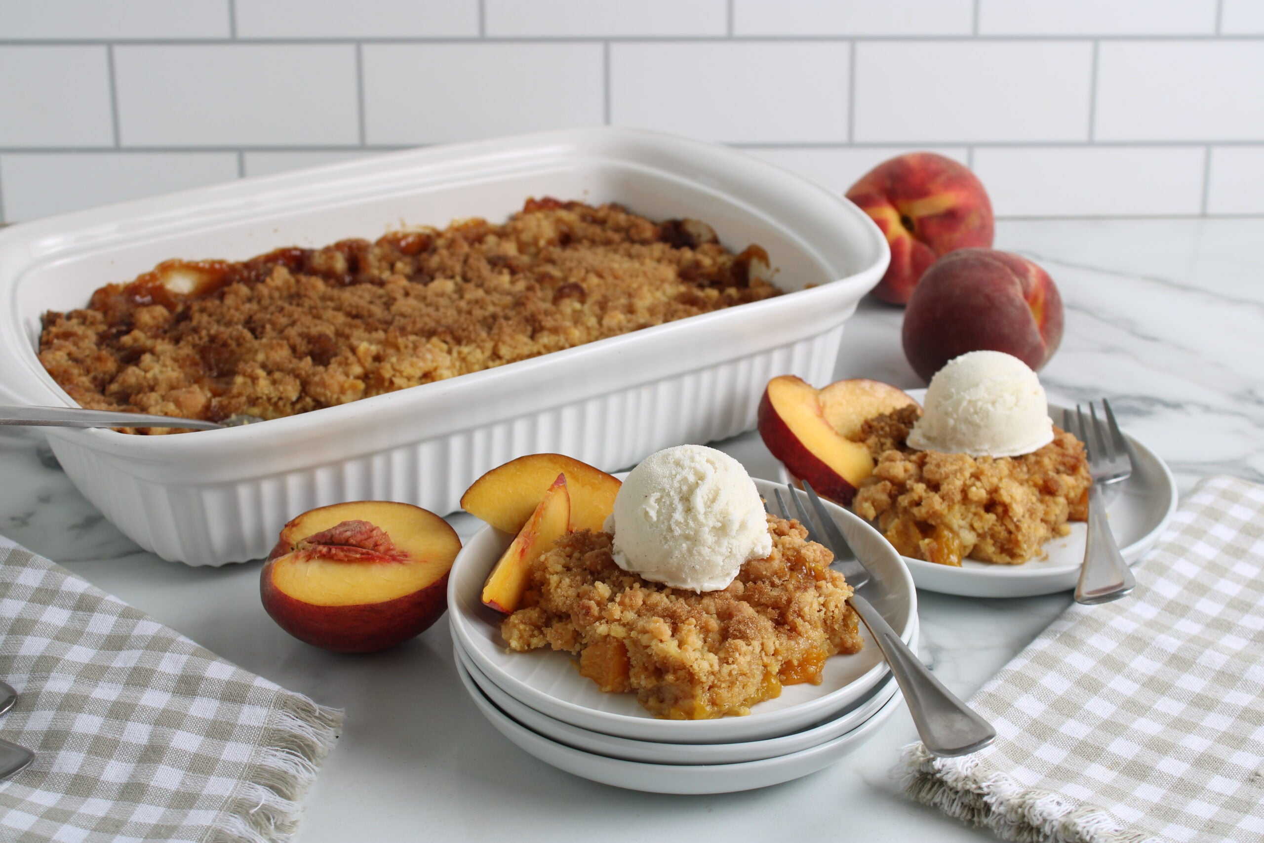 Cake Mix Peach Cobbler Baked and plated with vanilla ice cream