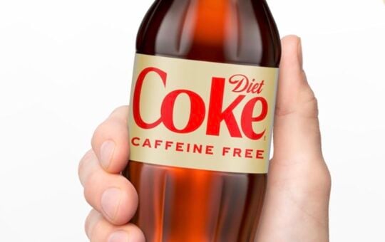 caffeine free diet coke bottle in hand