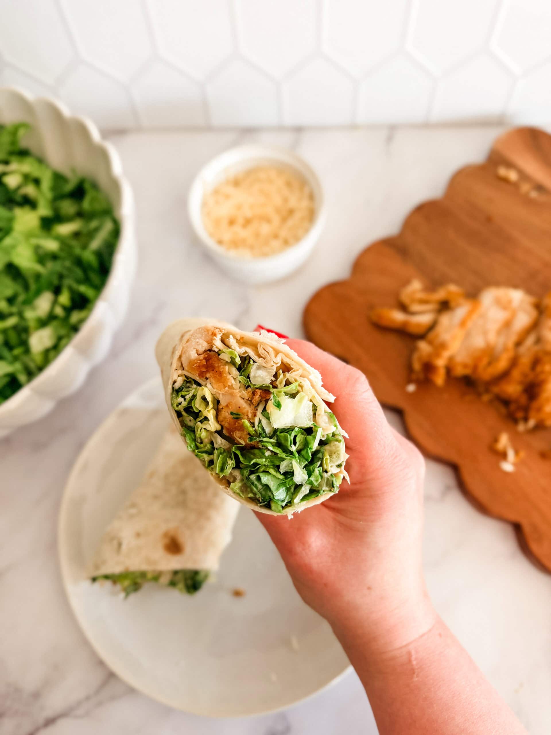 chicken caesar wraps in hand