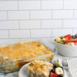 Biscuits and Gravy Casserole finished and plated on white plate with fruit