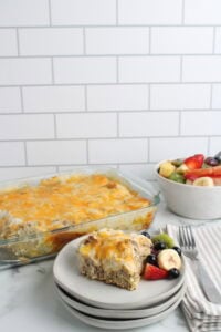 Biscuits and Gravy Casserole finished and plated on white plate with fruit