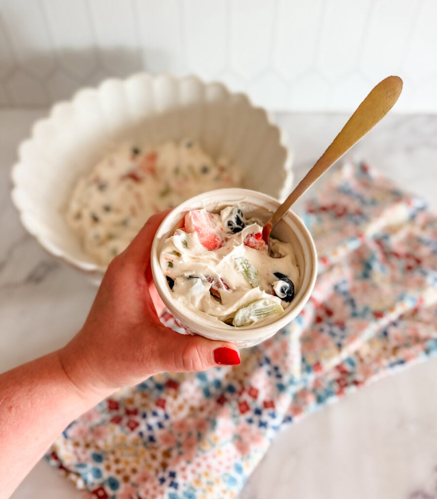 fruity cheesecake salad in bowl with spoon fruity cheesecake salad in bowl with spoon