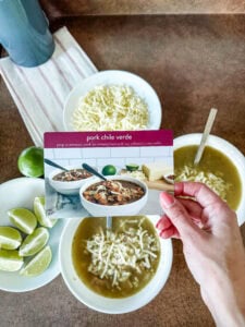 pork chile verde in bowls with recipe card